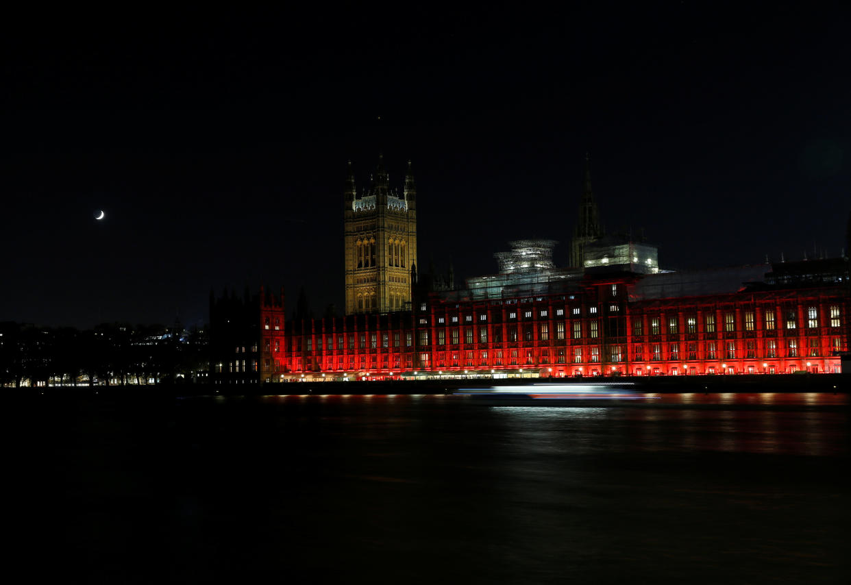 The Houses of Parliament in Westminster are floodlit in red light to mark #RedWednesday on&nbsp;Nov. 22 in London, England.