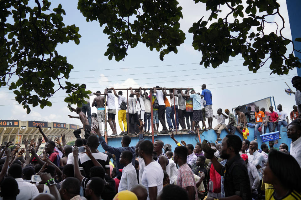 Supporters of spurned Congo opposition candidate Martin Fayulu wait for his arrival in Kinshasha, Congo, Friday, Jan. 11, 2019. Hundreds gathered to denounce what they called "the people's stolen victory" in the presidential election. (AP Photo/Jerome Delay)