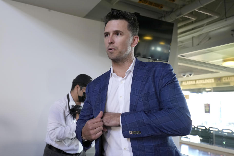 San Francisco Giants catcher Buster Posey arrives to talk with the media during a news conference announcing his retirement from baseball, Thursday, Nov. 4, 2021, in San Francisco. (AP Photo/Tony Avelar)