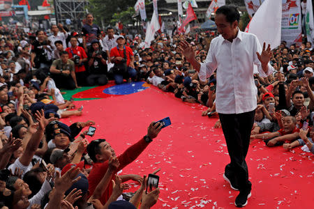 FILE PHOTO: Indonesia's presidential candidate Joko Widodo gestures as he greets his supporters at a carnival during a campaign rally in Tangerang, Banten province, Indonesia, April 7, 2019. REUTERS/Willy Kurniawan/File Photo