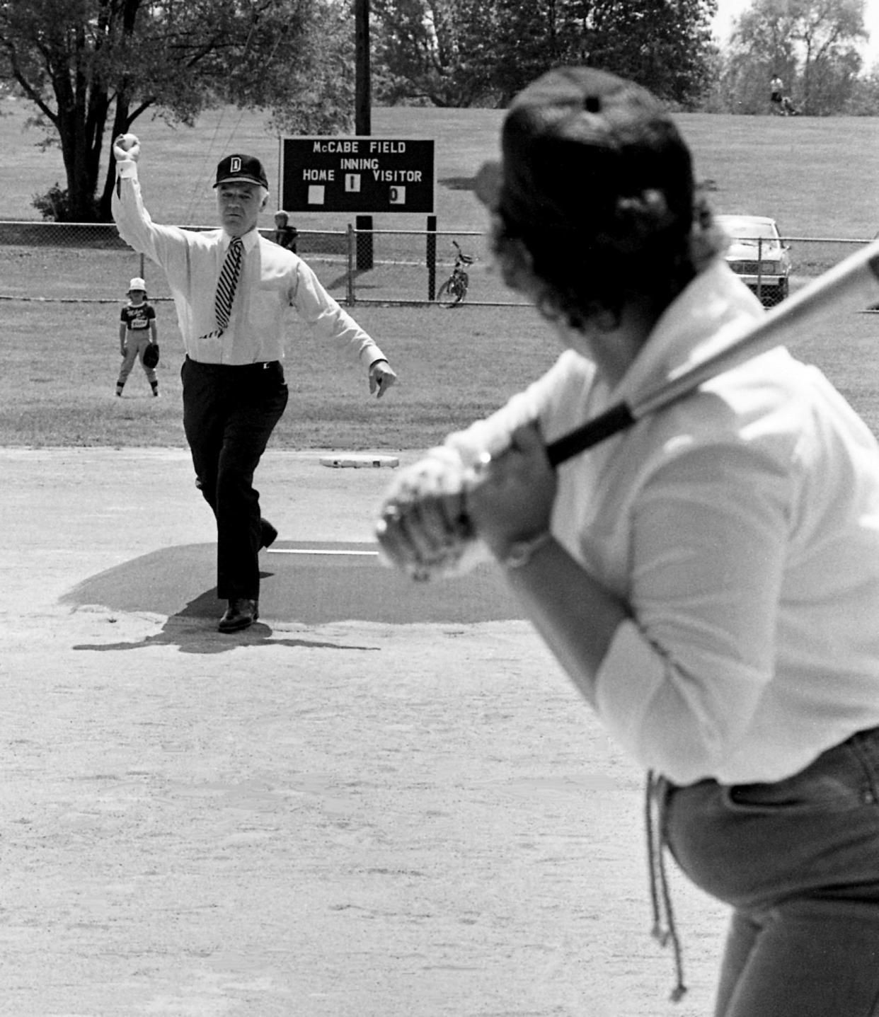 Metro mayor Richard Fulton, left, serves up his best pitch while facing Session Court judge Barbara Hayes during their appearance for opening day ceremonies for the youth leagues at McCabe Park May 7, 1983.