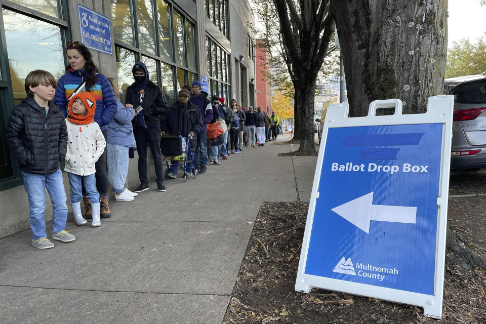 FILE - Dozens of people stand in line on Election Day at the Multnomah County Elections Office in Portland, Ore., Tuesday, Nov. 8, 2022. Oregon is losing its second elections director in as many years with the current one announcing her resignation, saying the job is extremely challenging and complaining of uncertain funding. (AP Photo/Claire Rush, File)