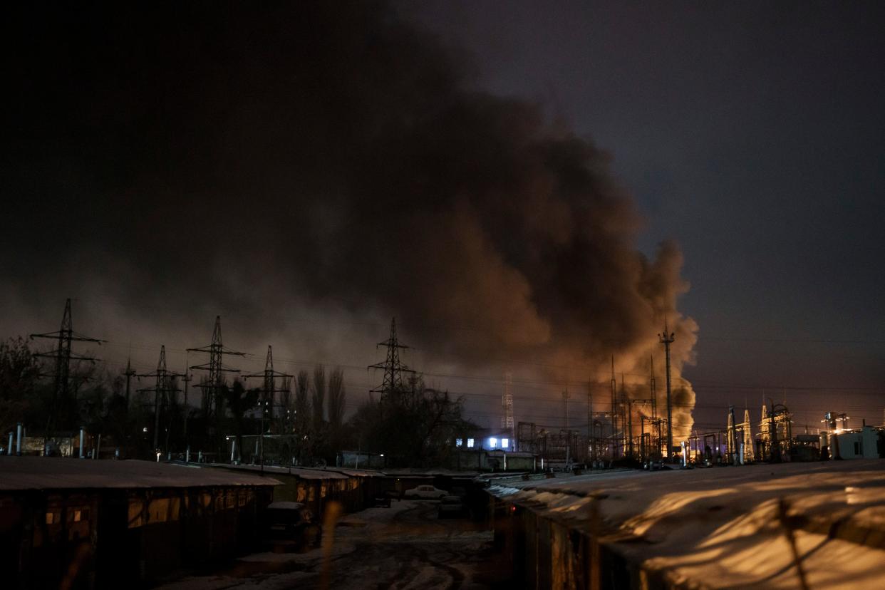 Smoke billows from a power infrastructure following a Russian drone attack in Kyiv Oblast on 19 December (AP)