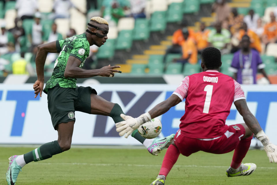 Nigeria's Victor Osimhen, left, kicks the ball against Equatorial Guinea's goalkeeper Jesus Owono during the African Cup of Nations Group A soccer match between Nigeria and Equatorial Guinea's in Abidjan, Ivory Coast, Sunday, Jan. 14, 2024. (AP Photo/Sunday Alamba)