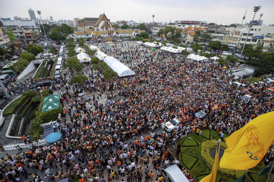 Pita Limjaroenrat, leader of Move Forward Party, stands in a car at bottom center, as he is driven through a crowd of supporters in Bangkok, Monday, May 15, 2023. Fresh off a stunning election victory in which they together captured a majority of seats in the House of Representatives, Thailand's top two opposition parties began planning Monday for the next stage in their bid to replace the military-dominated government. (AP Photo/Wason Wanichakorn)