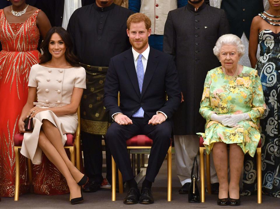 Duchess Meghan (from left) and Prince Harry make the royal rounds with Queen Elizabeth II in 2018.