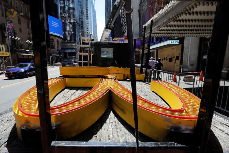 Workers remove a sign from a permanently closed McDonald's restaurant in Times Square in New York