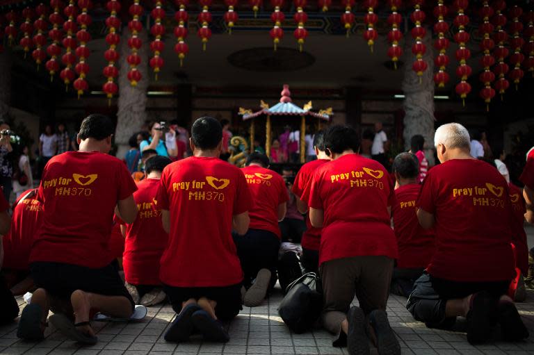 Relatives of passengers from the missing Malaysia Airlines flight MH370 offer prayers at Thean Hou Temple in Kuala Lumpur, on March 1, 2015