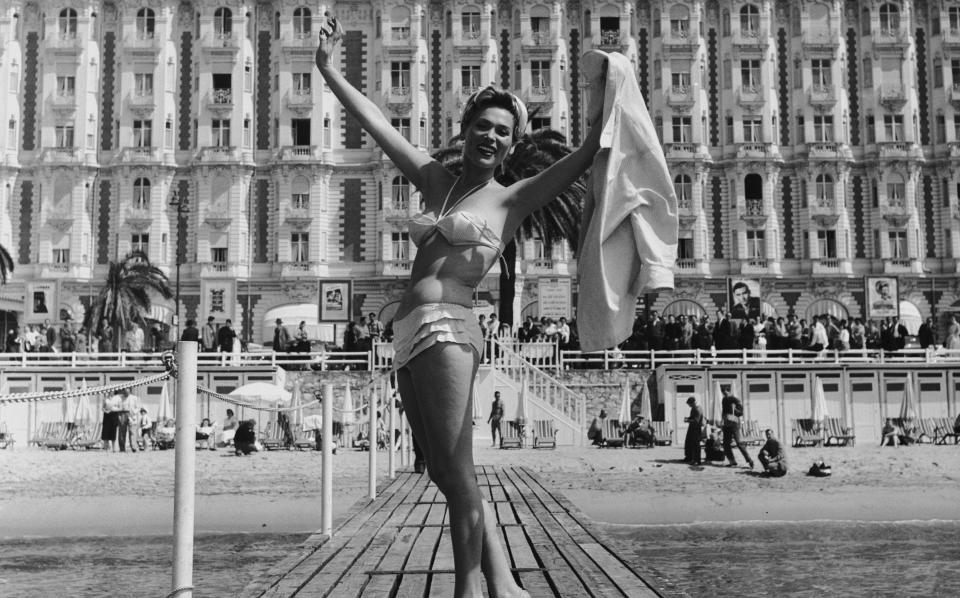 Polish actor Bella Darvi poses in front of the Carlton Hotel, iconic to Cannes, in 1956