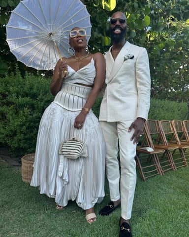 <p>Aisha Hinds Instagram</p> Aisha Hinds and Nigel Walker pose for a picture together outdoors.