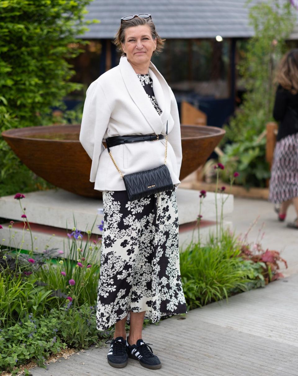 Kjersti Wiklund, 63, wears a Toteme dress with a Style In jacket. Her bag is Miu Miu and trainers are Adidas