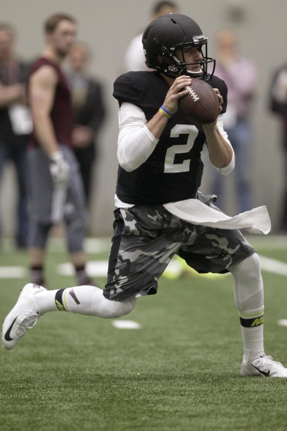 Texas A&M quarterback Johnny Manziel passes the ball during a drill at pro day for NFL football representatives in College Station, Texas, Thursday, March 27, 2014. (AP Photo/Patric Schneider)