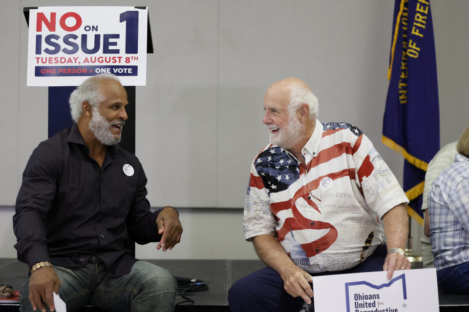 Bryan Phipps, left, and Chuck Taylor, both from Columbus, talk while waiting for election results during a watch party Tuesday, Aug. 8, 2023, in Columbus, Ohio. (AP Photo/Jay LaPrete)