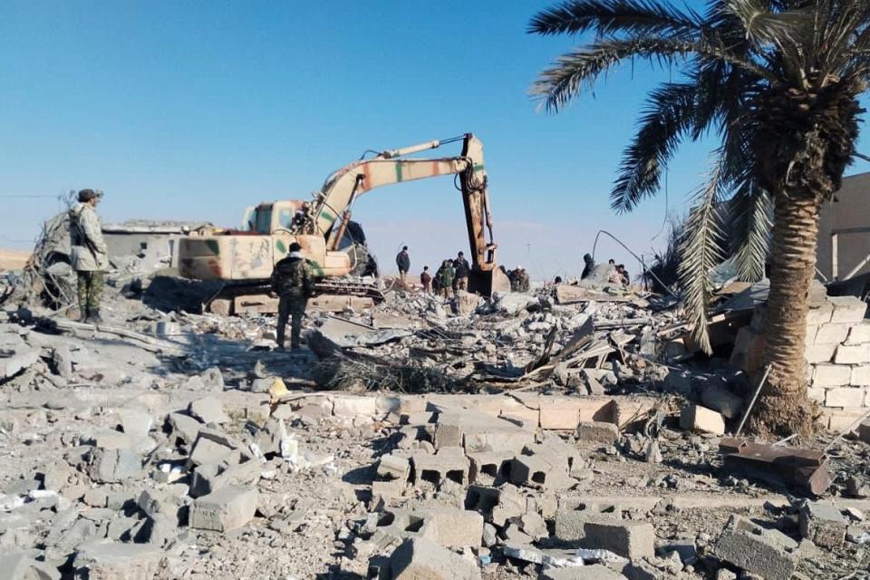 Members of Iraqi Shiite Popular Mobilization Forces clean the rubble after a U.S. airstrike in al-Qaim, Iraq, Saturday, Feb. 3, 2024. The U.S. Central Command said in a statement on Friday that the U.S. forces conducted airstrikes on more than 85 targets in Iraq and Syria against Iran's Islamic Revolutionary Guards Corps and affiliated militia groups.