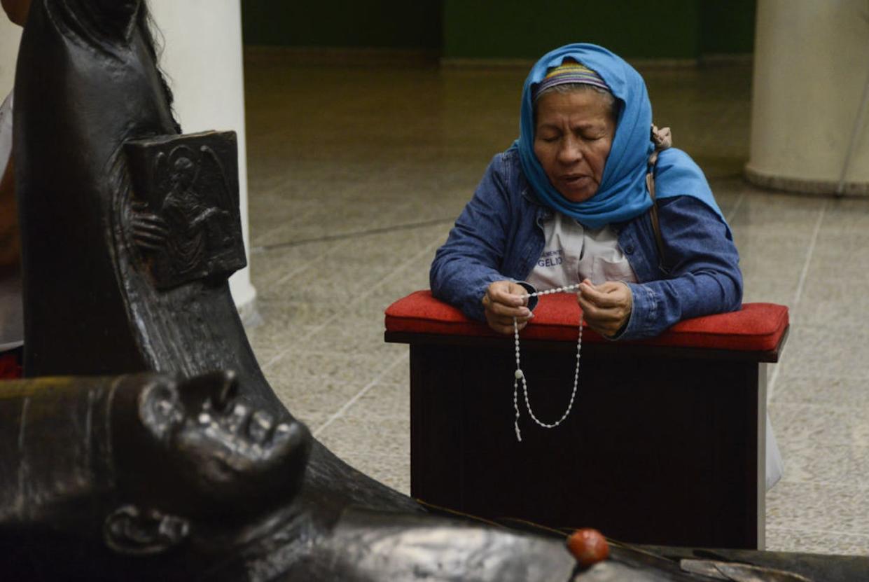 A woman prays in front of a statue of the martyred Catholic archbishop of El Salvador, Oscar Romero, known for his embrace of liberation theology. <a href="https://www.gettyimages.com/detail/news-photo/woman-prays-in-front-of-a-statue-of-the-martyred-archbishop-news-photo/999042682?phrase=%22liberation%20theology%22&adppopup=true" rel="nofollow noopener" target="_blank" data-ylk="slk:Vlady Chicas/picture alliance via Getty Images;elm:context_link;itc:0;sec:content-canvas" class="link ">Vlady Chicas/picture alliance via Getty Images</a>