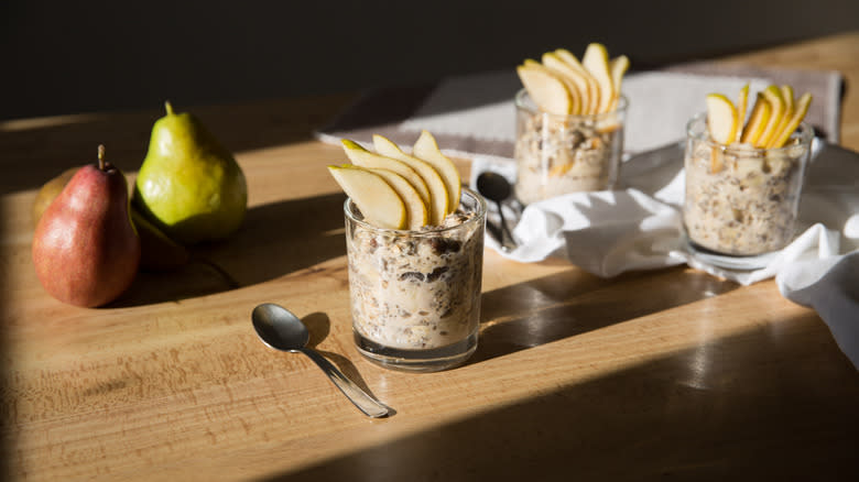 pear overnight oats in glasses on wood table