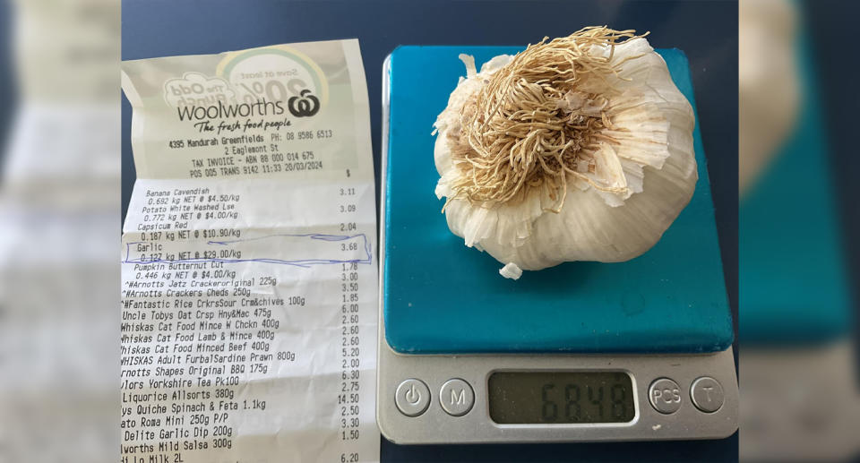 Woolworths receipt next to home kitchen scale with garlic.