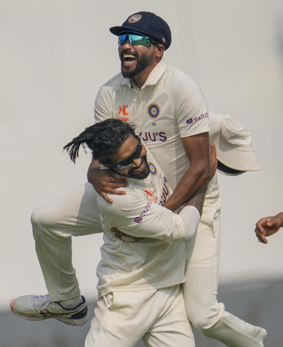 India's Mohammed Siraj leaps on the back of Ravindra Jadeja after he took his seventh wicket during the third day of the second cricket test match between India and Australia in New Delhi, India, Sunday, Feb. 19, 2023. (AP Photo/Altaf Qadri)