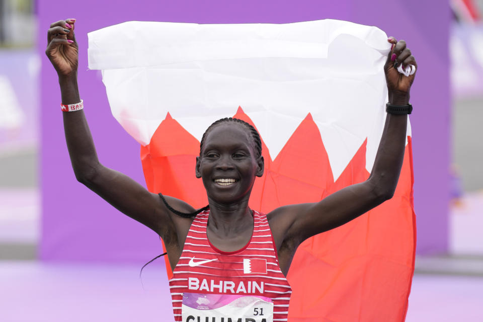 Bahrain's Eunice Chebichii Paul Chumba celebrates after winning the women's marathon at the 19th Asian Games in Hangzhou, China, Thursday, Oct. 5, 2023. (AP Photo/Aijaz Rahi)