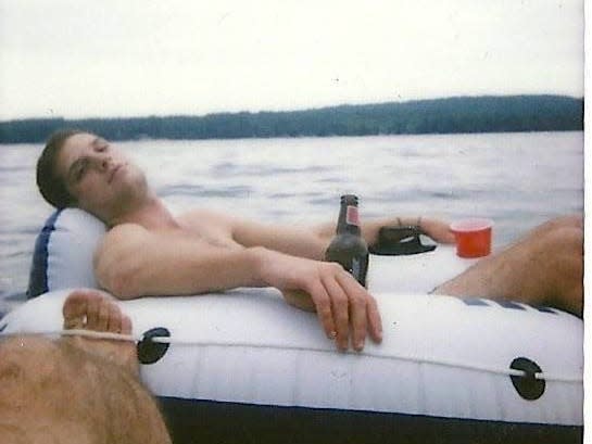 Evan Gershkovich sitting in an inner tube in Long Lake, Maine, in 2013.