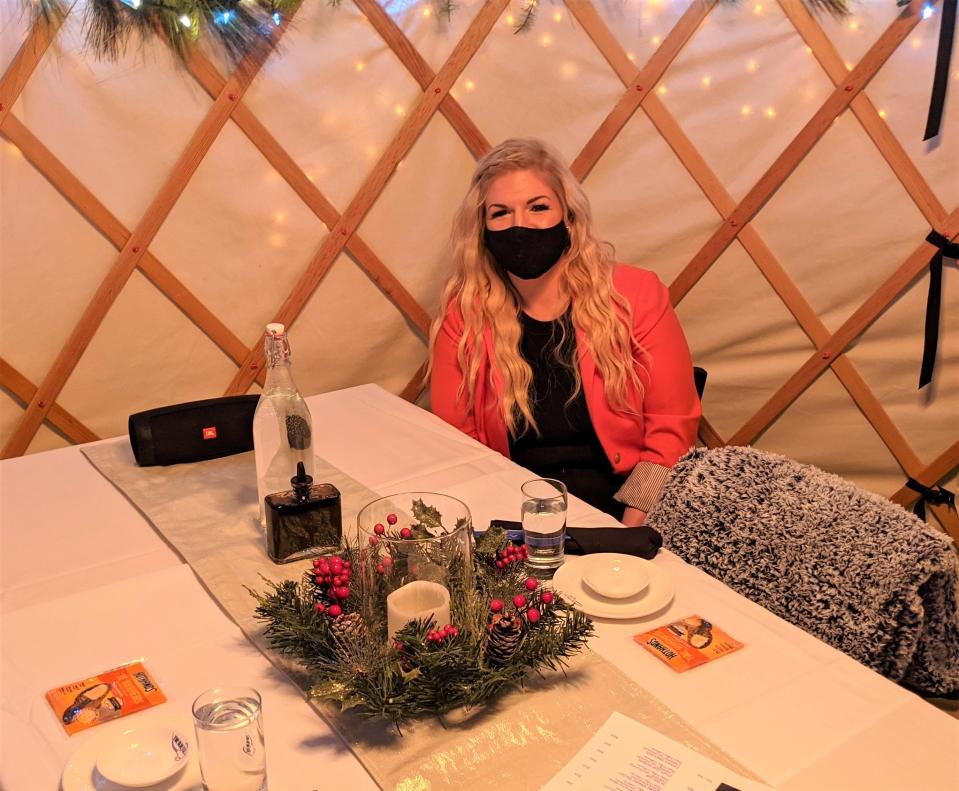 Shannon Foley, general manager of The Blue Fish in Breckenridge, sits in the comfy outdoor yurt, which comes with blankets and toe warmers for cold nights.