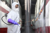 A member from an emergency anti-epidemic headquarters in Mangyongdae District disinfects a tramcar of Songsan Tram Station to prevent new coronavirus infection in Pyongyang, North Korea Wednesday, Feb. 26, 2020. Uncertainly remained over how best to stem the spread of the illness. (AP Photo/Cha Song Ho)