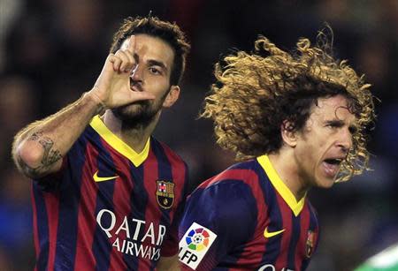 Barcelona's Cesc Fabregas (L) celebrates next to Carles Puyol after scoring against Real Betis during their Spanish First Division soccer match at Benito Villamarin stadium in Seville, November 10, 2013. REUTERS/Marcelo del Pozo