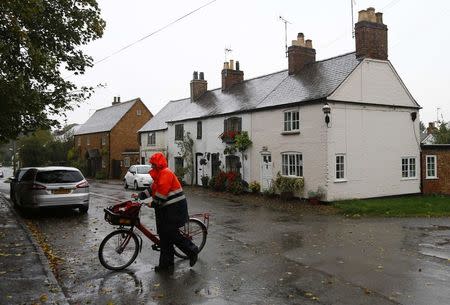 A postal worker delivers letters in the village where Brenda Leyland lived, at Burton Overy in central England October 6, 2014. REUTERS/Darren Staples