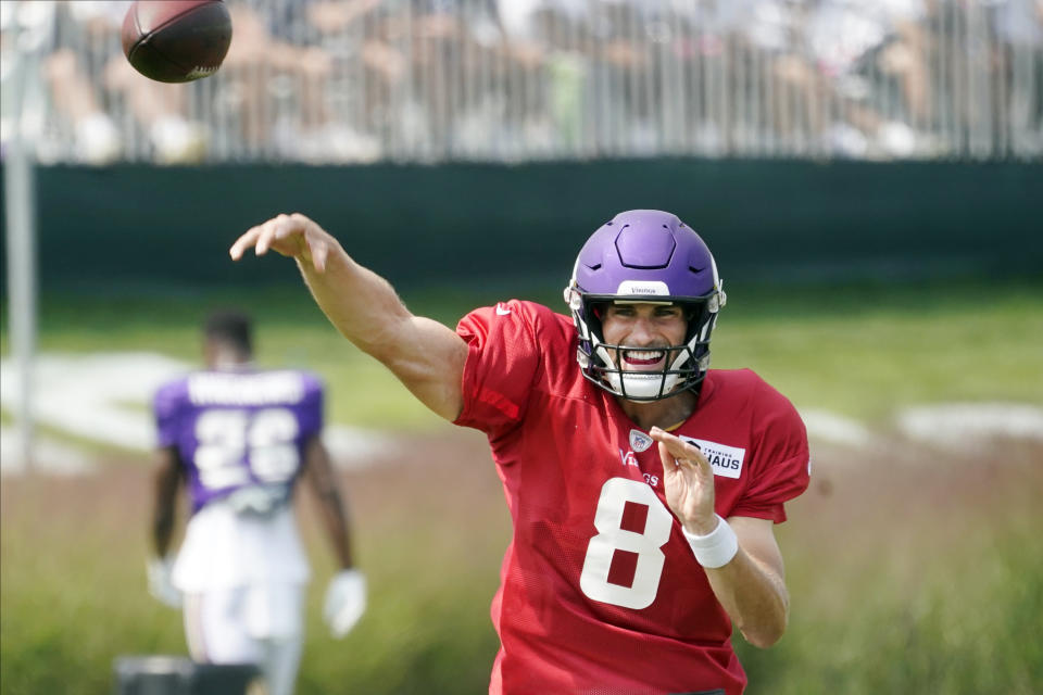 Minnesota Vikings quarterback Kirk Cousins (8) throws during the NFL football team's training camp, Friday, Aug. 6 2021, in Eagan, Minn. (AP Photo/Jim Mone)