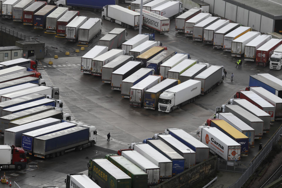 Trucks are parked in Dover, whilst the Port remains closed, in Kent, England, Tuesday, Dec. 22, 2020. Trucks waiting to get out of Britain backed up for miles and people were left stranded at airports as dozens of countries around the world slapped tough travel restrictions on the U.K. because of a new and seemingly more contagious strain of the coronavirus in England. (AP Photo/Kirsty Wigglesworth)