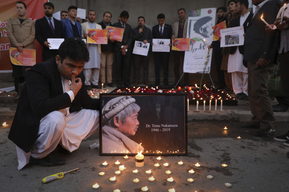 Afghans attend a candle lit vigil in Kabul, Afghanistan on Thursday, Dec. 5, 2019, in memory of Tetsu Nakamura, a Japanese physician engaged in aid work who was killed Wednesday, Dec. 4 in a shooting in eastern Afghanistan. (AP Photo/Altaf Qadri)