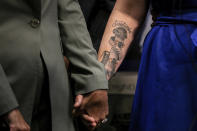 Attorney Annee Della Donna, left, clutches the hand of Christiana Sweetwood, mother of Marine Lance Cpl. Chase Sweetwood, during a press conference on Thursday, July 29, 2021 in Oceanside, Calif. The families of eight Marines and one sailor who died when their amphibious assault vehicle sank off the Southern California coast in the summer of 2020 plan to sue the manufacturer of the vehicle that resembles an armored seafaring tank, their lawyers announced Thursday. (Sam Hodgson/The San Diego Union-Tribune via AP)