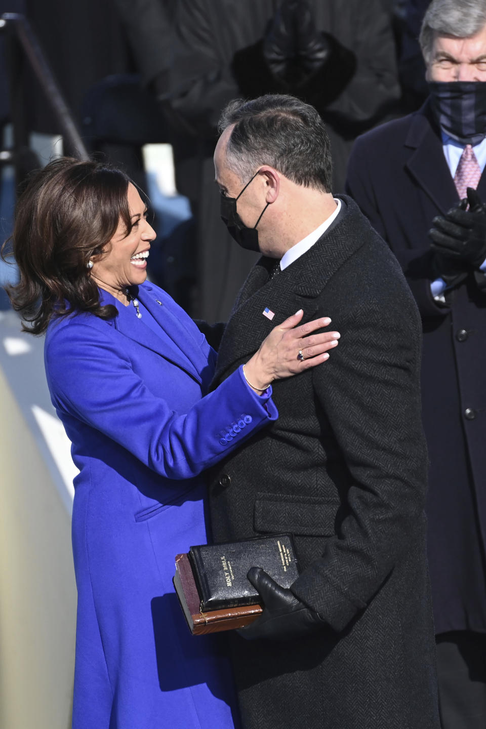 Vice President Kamala Harris is embraced by her husband Doug Emhoff after she was sworn into office during the 59th Presidential Inauguration at the U.S. Capitol in Washington, Wednesday, Jan. 20, 2021.(Saul Loeb/Pool Photo via AP)