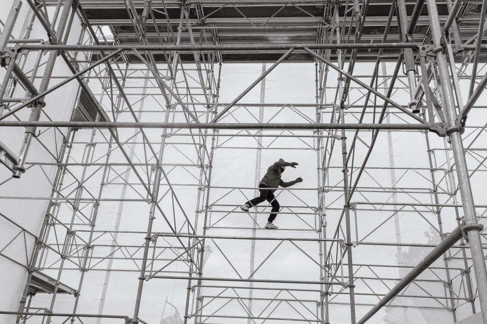 A pro-Trump rioter climbs the scaffolding outside of the Capitol.<span class="copyright">Christopher Lee for TIME</span>