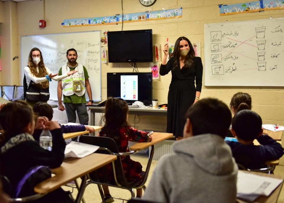 Meghan holds up a marker pen as the school children shout out the English words for the colours (SSgt Jake Carter, Task Force Liberty public affairs/PA)