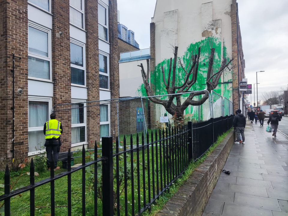 A council worker attempts to remove the tags (Barney Davis)