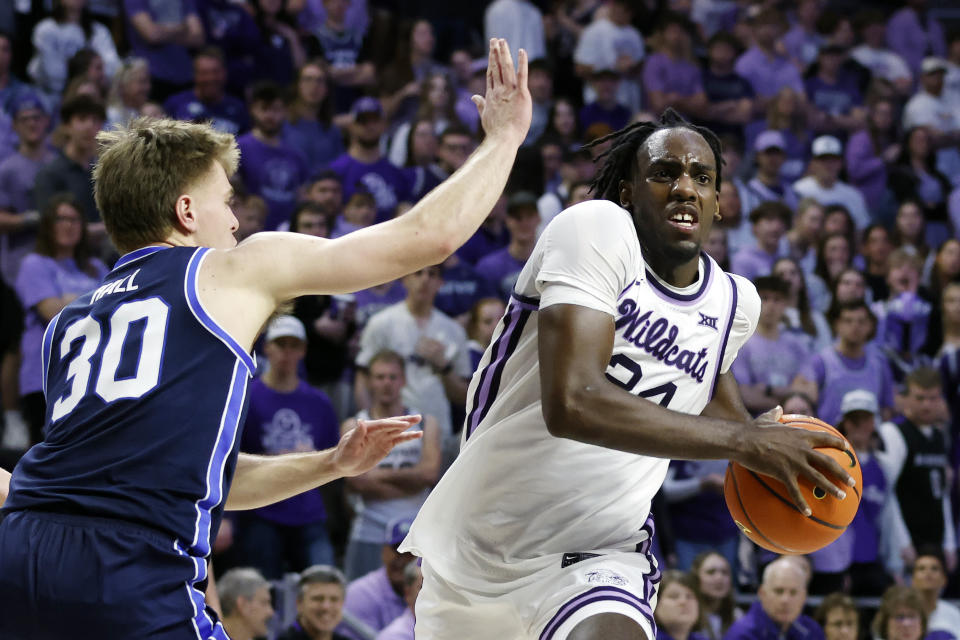 Kansas State forward Arthur Kaluma (24) drives toward the basket as BYU guard Dallin Hall (30) defends during the second half of an NCAA college basketball game, Saturday, Feb. 24, 2024, in Manhattan, Kan. (AP Photo/Colin E. Braley)