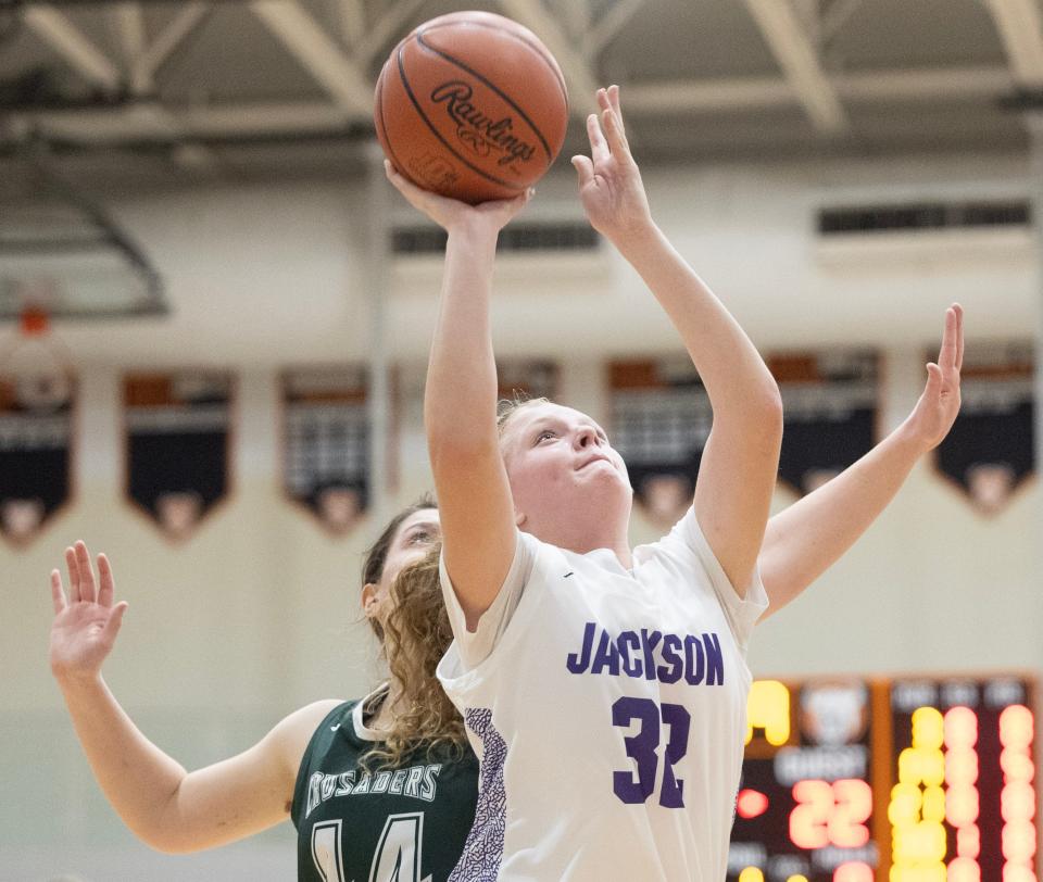 Jackson's Alexa Pizor shoots while trailed by Central Catholic's Alicia Varacky in the second half of Wednesday's game.