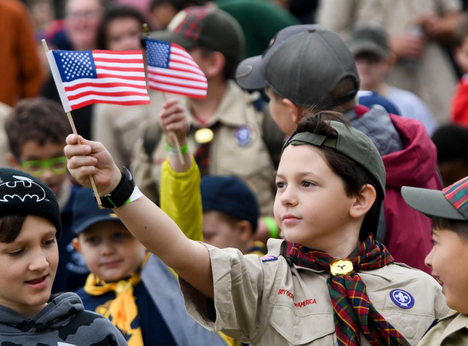 Oct 29, 2022; Tuscaloosa, AL, USA; Mason Owenby, a Webelo Scout from Lakeview, waves his flag as Boys Scouts in the Black Warrior Council gathered in the Moundville Archaeological Park to celebrate their 100th anniversary encampment Saturday.