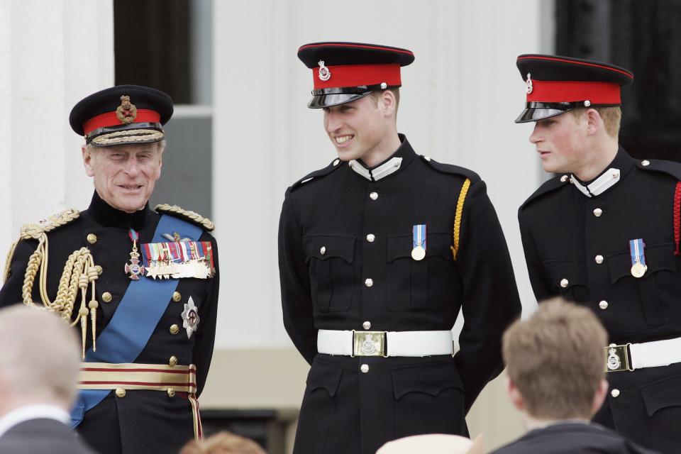 Prince Philip with Prince William and Prince Harry in military outfits