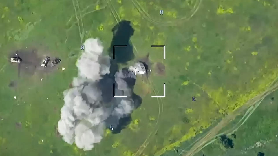 This photo taken from video released by Russian Defense Ministry Press Service on Monday, June 5, 2023, show a Ukrainian military vehicle being hit during a combat in Ukraine. The Russian Defense Ministry said the Russian military fended off an attempt by Ukraine to launch an attack in the southern part of the Donetsk region on Sunday. (Russian Defense Ministry Press Service via AP)