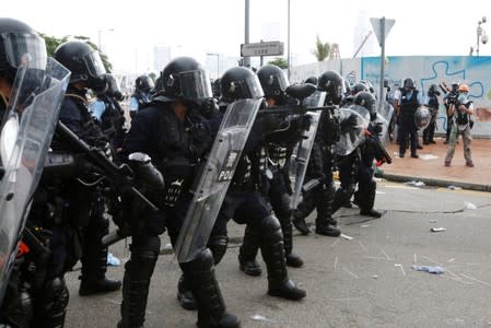 Riot police officers prepare for protesters during a demonstration against a proposed extradition bill, in Hong Kong