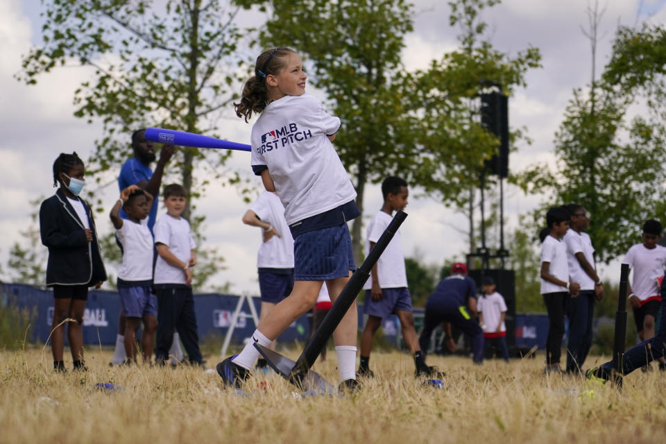 A kid hits a baseball during the MLB First Pitch Festival, at the Queen Elizabeth Olympic Park, in London, Thursday, June 22, 2023. Britain's relative success at the World Baseball Classic and the upcoming series between the Chicago Cubs and St. Louis Cardinals has increased London's interest about baseball. The sport's governing body says it has seen an uptick in interest among kids. (AP Photo/Alberto Pezzali)