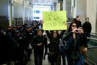 A woman holds a sign during a protest rally against Republican presidential front-runner Donald Trump in New York on March 19, 2016