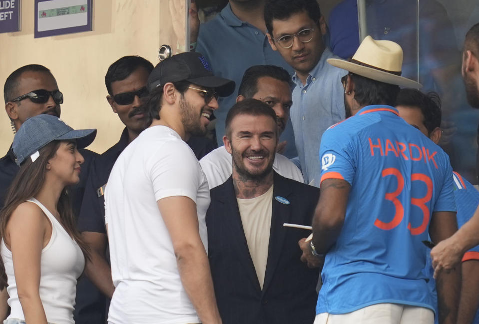 Former soccer star David Beckham talks to India's Hardik Pandya during the ICC Men's Cricket World Cup first semifinal match between India and New Zealand in Mumbai, India, Wednesday, Nov. 15, 2023. (AP Photo/Rafiq Maqbool)