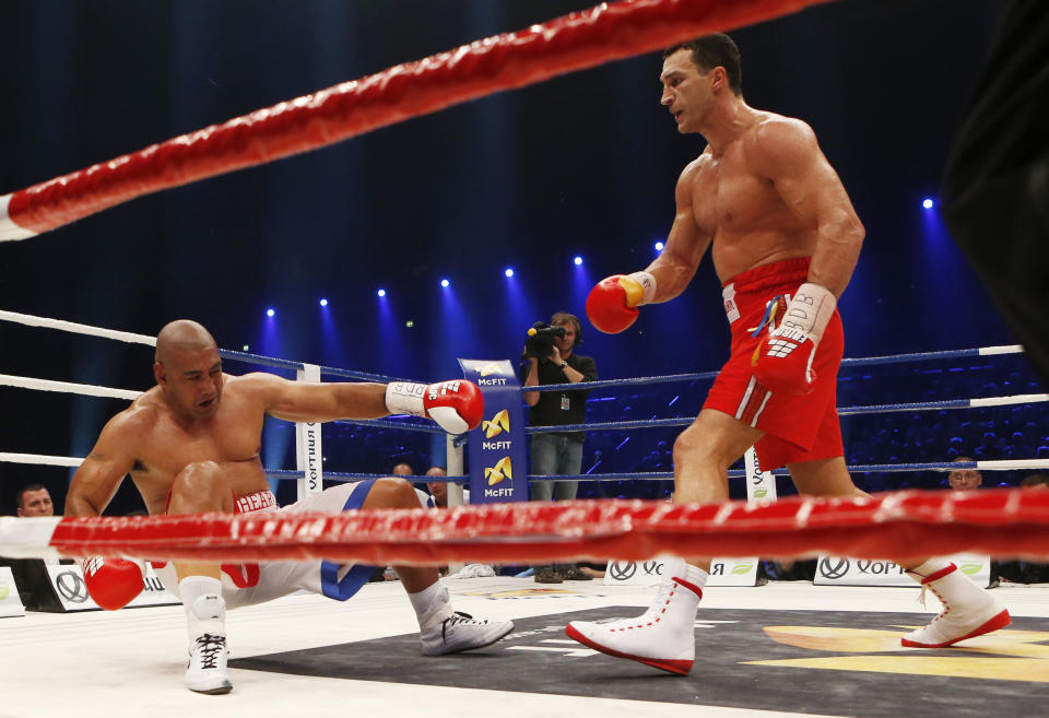 IBF, WBA, WBO and IBO champion Wladimir Klitschko from Ukraine, right, knocks down his Australian challenger Alex Leapai during their heavyweight world title bout in Oberhausen, western Germany, Saturday, April 26, 2014. (AP Photo/Frank Augstein)