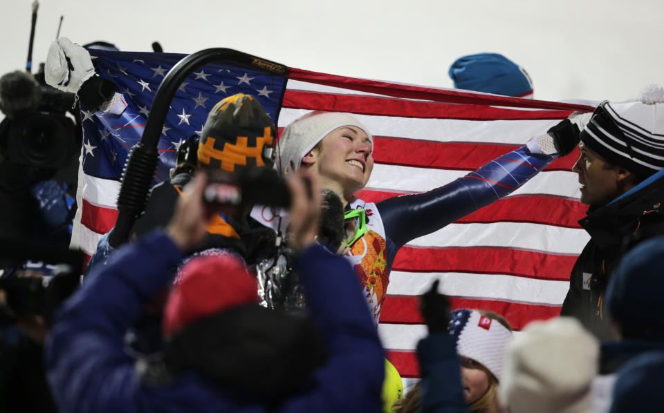 United States' Mikaela Shiffrin poses with the American flag after winning the gold medal in the women's slalom at the Sochi 2014 Winter Olympics, Friday, Feb. 21, 2014, in Krasnaya Polyana, Russia. (AP Photo/Charles Krupa)