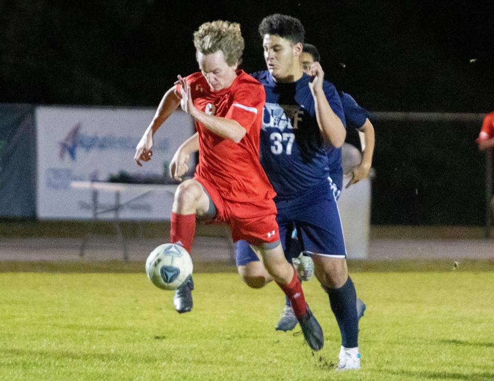 All Saints midfielder Nate Yoder makes a run toward the goal against Tampa Univeral on Thursday night in the championship match of the Class 2A, District 7 boys soccer tournament at Sants Fe Catholic.