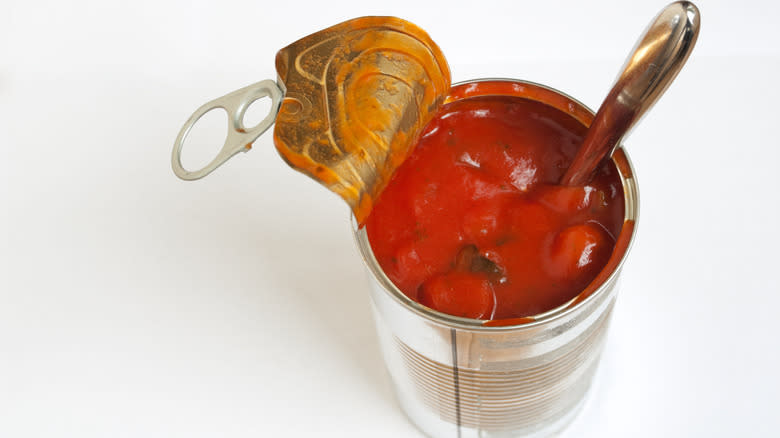Tomato soup in a can with spoon