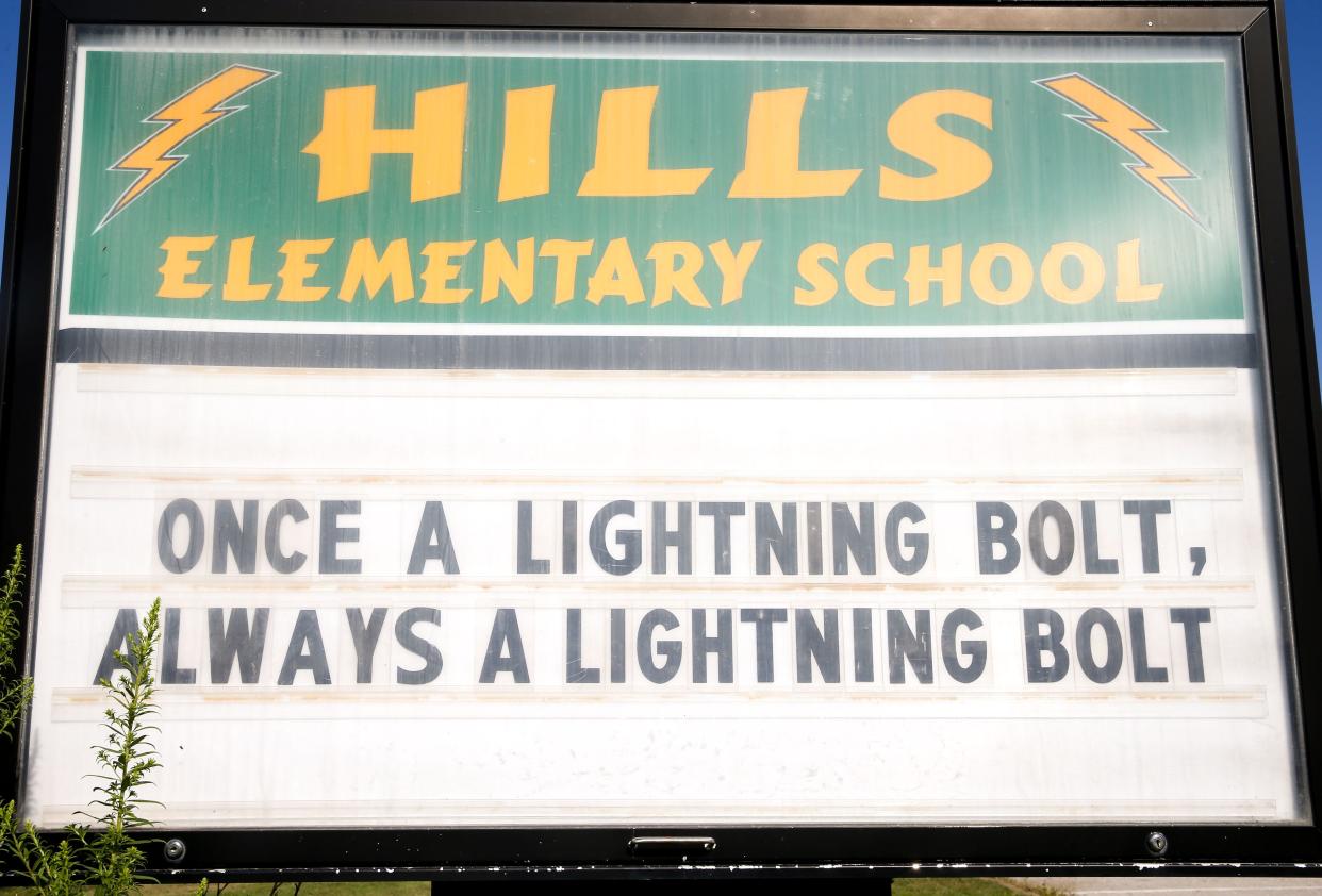 A sign reading “Once a lightning bolt, always a lightning bolt” is pictured outside Hills Elementary School Wednesday, Aug. 21, 2024 in Hills, Iowa.